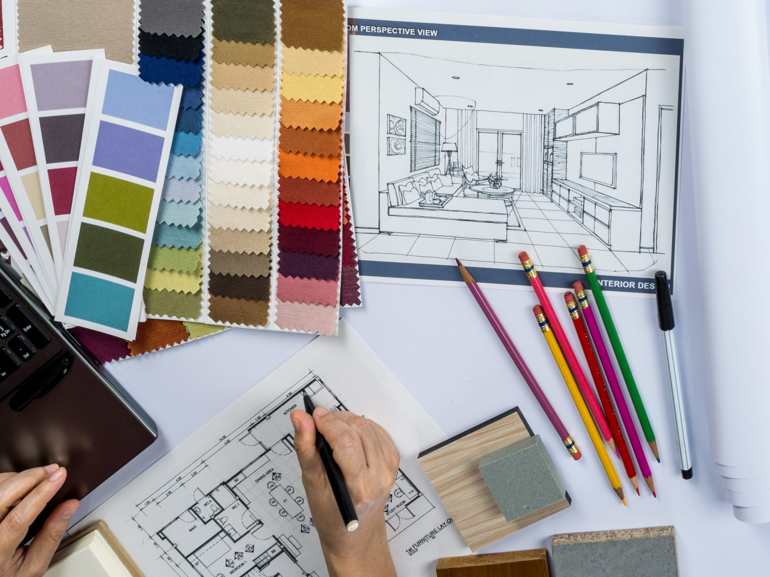 Architects/ interior designer hands drawing of house on creative desk